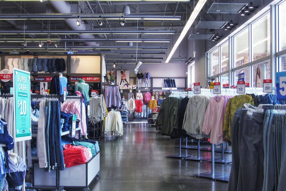 Large store with women's clothing for sale on racks
