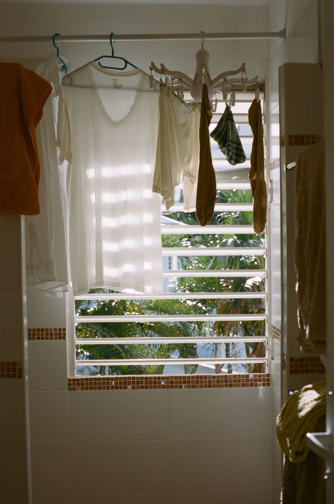 Clothes hanging to dry in a bathroom