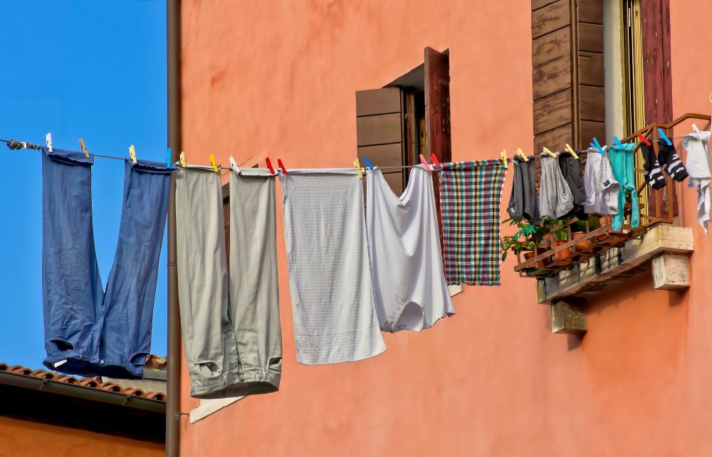 Laundry hanging from a line outside from an upperstorey window