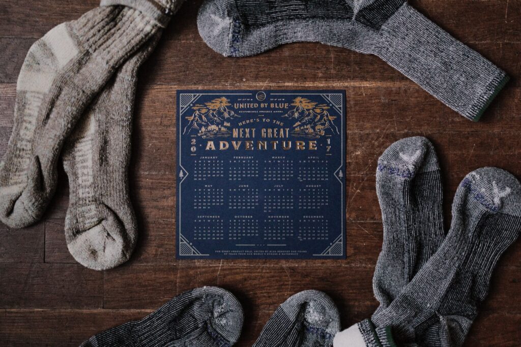Calendar on a table with worn wool socks around it.